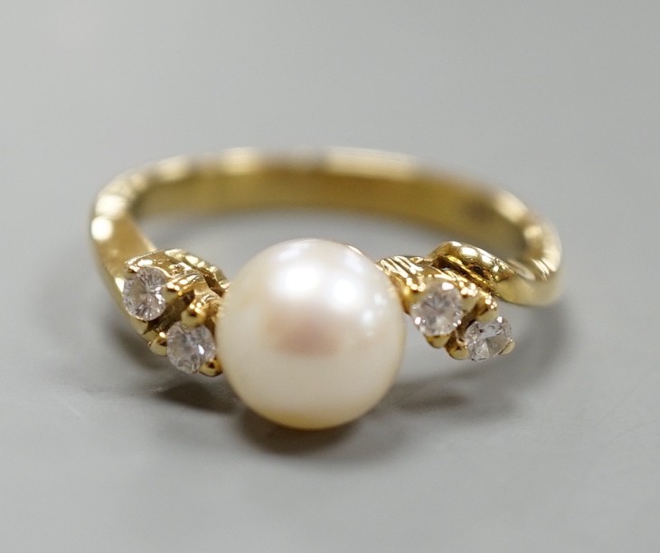 A 14kt yellow metal and single stone cultured pearl ring, with diamond set shoulders, size J, gross weight 3.4 grams.